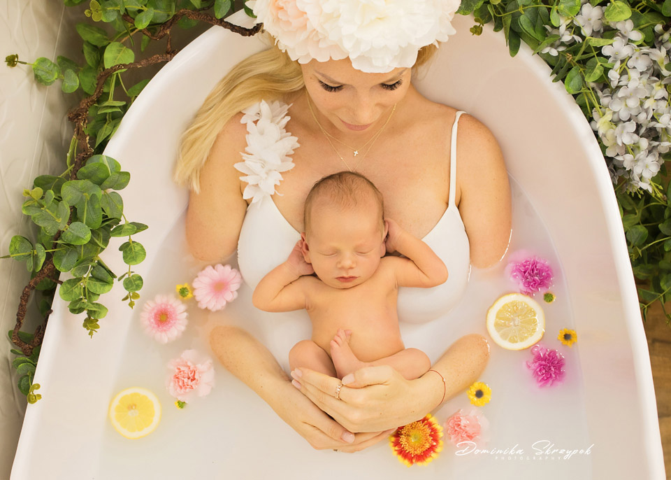 Mum with her newborn in a milk and flower bath in the studio in Gocław