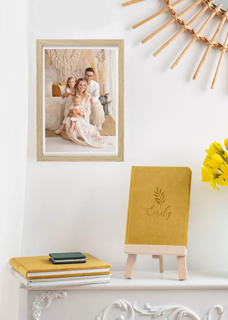 Framed family photos and a photo album in a studio in Warsaw