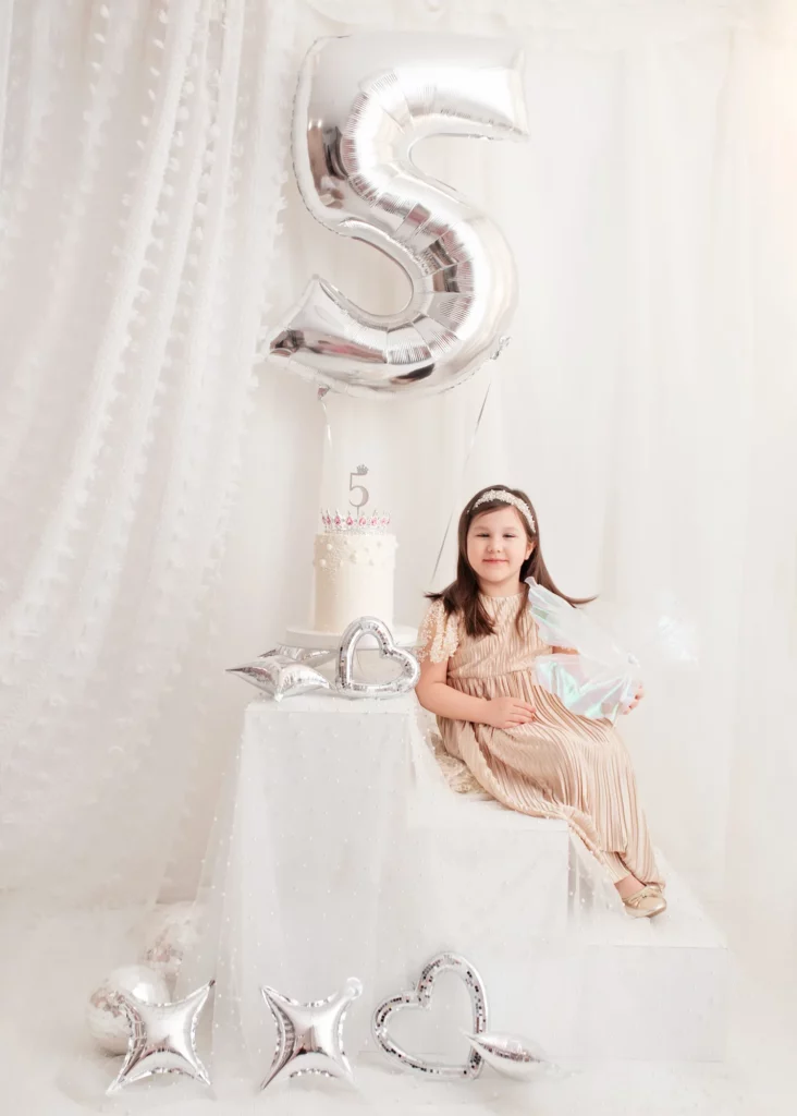 A girl by her birthday cake in the studio in Warsaw — children’s session